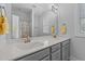 Bathroom featuring a double vanity with marble countertops and framed mirror at 1013 Sagamore Dr, Louisburg, NC 27549
