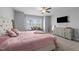 Spacious bedroom with large window, dresser with TV, and comfortable seating area at 1013 Sagamore Dr, Louisburg, NC 27549