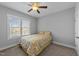 Well-lit bedroom with yellow bedding, ceiling fan, a window with blinds at 1013 Sagamore Dr, Louisburg, NC 27549