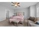 Well-lit bedroom with stylish furnishings, including a tufted headboard, bench, and seating area at 1013 Sagamore Dr, Louisburg, NC 27549