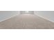 Expansive bonus room with neutral carpet and ample natural light from a window at 1013 Sagamore Dr, Louisburg, NC 27549
