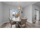 Elegant dining area with lake views, a modern light fixture, and seating for four, perfect for intimate meals at 1013 Sagamore Dr, Louisburg, NC 27549