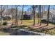 Charming home with a spacious deck overlooking a serene lake, surrounded by mature trees and a rock shoreline at 1013 Sagamore Dr, Louisburg, NC 27549