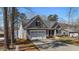 Charming home featuring a gray exterior, attached garage, and well-maintained landscaping at 1013 Sagamore Dr, Louisburg, NC 27549