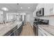 Open kitchen featuring a large island, stainless steel appliances, and seamless flow into the dining and living areas at 1013 Sagamore Dr, Louisburg, NC 27549