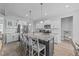 Bright kitchen featuring white cabinets, stainless steel appliances, and a large center island with bar stool seating at 1013 Sagamore Dr, Louisburg, NC 27549