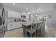 Spacious kitchen boasts white cabinets, a gray island with seating, and views of the lake from the adjacent dining area at 1013 Sagamore Dr, Louisburg, NC 27549
