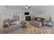 Cozy living room features a fireplace, lake views, and access to a deck, perfect for relaxing and entertaining at 1013 Sagamore Dr, Louisburg, NC 27549
