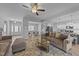 Open-concept living room showcases a modern design with light gray walls and seamless flow to the dining and kitchen areas at 1013 Sagamore Dr, Louisburg, NC 27549