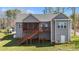 Rear exterior view showcasing a spacious deck, screened porch, and well-maintained yard at 1013 Sagamore Dr, Louisburg, NC 27549