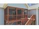 Cozy screened porch with wood railings, providing a relaxing outdoor living space at 1013 Sagamore Dr, Louisburg, NC 27549