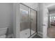 Walk-in shower featuring glass enclosure, gray tiles, and built in shower caddy at 1013 Sagamore Dr, Louisburg, NC 27549