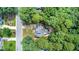 Aerial view of a home and property surrounded by mature trees in a quiet neighborhood at 107 E Seve Ct, Morrisville, NC 27560