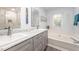 Bathroom featuring double sinks, vanity with marble countertop, and a soaking tub at 107 E Seve Ct, Morrisville, NC 27560