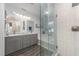 Modern bathroom with dual sinks, glass-enclosed shower, and a luxurious soaking tub at 107 E Seve Ct, Morrisville, NC 27560