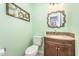 Stylish half-bath features a mosaic countertop and decorative mirror at 107 E Seve Ct, Morrisville, NC 27560