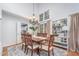 Dining room featuring wood floors, a chandelier, a table with six chairs, and a large window at 107 E Seve Ct, Morrisville, NC 27560