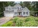 Well-maintained two-story home featuring a lush, landscaped front yard and attached two-car garage at 107 E Seve Ct, Morrisville, NC 27560