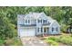 Beautiful two-story home with an attached two-car garage and manicured front yard landscaping at 107 E Seve Ct, Morrisville, NC 27560