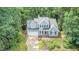 Charming two-story home featuring a lush, landscaped front yard and attached two-car garage at 107 E Seve Ct, Morrisville, NC 27560