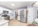 Bright kitchen features white cabinets, stainless steel appliances, and granite countertops at 107 E Seve Ct, Morrisville, NC 27560