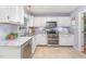 Well-lit kitchen featuring granite countertops, stainless steel appliances, and ample cabinet space at 107 E Seve Ct, Morrisville, NC 27560