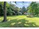 Expansive backyard with mature trees, shed, and garden area with ample space for outdoor activities at 108 High St, Carrboro, NC 27510