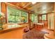 Detailed bathroom with wood paneling, large windows to the deck, vanity, and built in bath and shower at 108 High St, Carrboro, NC 27510