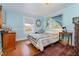Light and airy bedroom with hardwood floors and painted blue walls at 108 High St, Carrboro, NC 27510