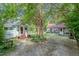 Charming exterior view of cottage-style home with inviting front porch and rustic shed at 108 High St, Carrboro, NC 27510
