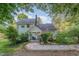 Charming two-story home with light green siding, brick chimney, and well-manicured front yard at 108 High St, Carrboro, NC 27510