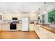 Well-lit kitchen with shaker cabinets, butcher block countertops, and a farmhouse sink at 108 High St, Carrboro, NC 27510