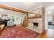 Inviting living room with exposed wood beams, brick fireplace, and hardwood floors at 108 High St, Carrboro, NC 27510