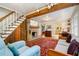 Bright living room featuring a brick fireplace, exposed beams, and hardwood floors at 108 High St, Carrboro, NC 27510