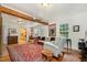 Open-concept living room with exposed beams, bright windows, and hardwood flooring at 108 High St, Carrboro, NC 27510