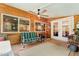 Comfortable screened porch featuring a ceiling fan, bright lighting, and wood paneling at 108 High St, Carrboro, NC 27510