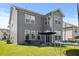 Home's backyard with a patio, furniture set, grill, trampoline, and plentiful windows for natural lighting at 120 Misty Grove Trail Trl, Franklinton, NC 27525