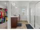 Bathroom showcasing a double sink vanity, a glass-enclosed shower, and access to a closet at 120 Misty Grove Trail Trl, Franklinton, NC 27525