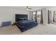 Spacious bedroom features plush carpeting and a comfortable, oversized bed with a tufted headboard at 120 Misty Grove Trail Trl, Franklinton, NC 27525