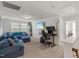 Upstairs bonus room featuring a comfortable blue sectional couch and an office area at 120 Misty Grove Trail Trl, Franklinton, NC 27525