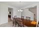 Bright dining room with a wooden table and views into an adjacent kitchen at 120 Misty Grove Trail Trl, Franklinton, NC 27525
