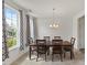 Bright dining room with large windows, elegant curtains, and a wooden dining table at 120 Misty Grove Trail Trl, Franklinton, NC 27525
