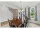 Open dining area featuring a wooden table, chandelier, and views to the stairway at 120 Misty Grove Trail Trl, Franklinton, NC 27525