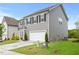 Two-story house with gray siding, black shutters, and a concrete driveway at 120 Misty Grove Trail Trl, Franklinton, NC 27525