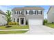 Well-maintained two-story home featuring gray siding, black shutters, and a spacious two-car garage at 120 Misty Grove Trail Trl, Franklinton, NC 27525