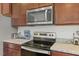 Close-up of the kitchen appliances, including a microwave and electric stovetop at 120 Misty Grove Trail Trl, Franklinton, NC 27525