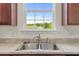Stainless steel kitchen sink with a view of the backyard at 120 Misty Grove Trail Trl, Franklinton, NC 27525