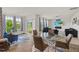 Open-concept living room featuring a glass table, comfortable seating, and an electric fireplace at 120 Misty Grove Trail Trl, Franklinton, NC 27525