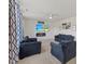 Comfortable living room featuring plush couches and a wall-mounted television at 120 Misty Grove Trail Trl, Franklinton, NC 27525
