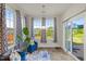 Cozy sunroom filled with natural light, comfortable seating, and a view of the outdoors at 120 Misty Grove Trail Trl, Franklinton, NC 27525